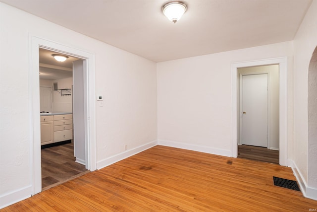 unfurnished room with wood-type flooring