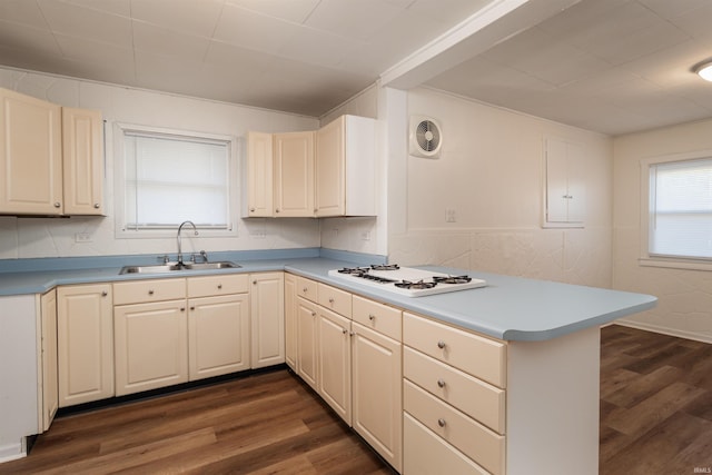 kitchen featuring kitchen peninsula, dark hardwood / wood-style flooring, white gas stovetop, and sink