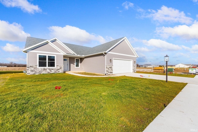 view of front of house with a garage and a front lawn