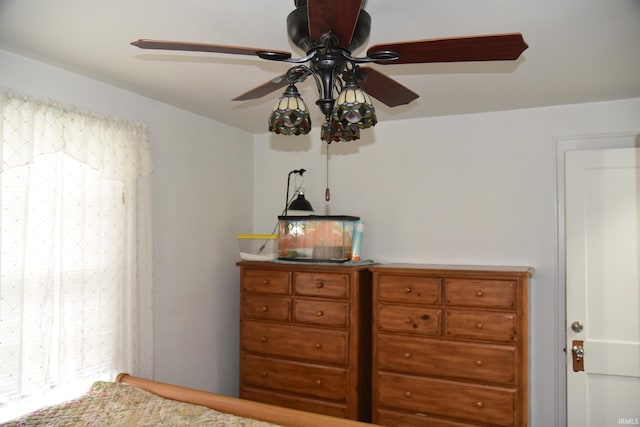 bedroom with multiple windows and ceiling fan