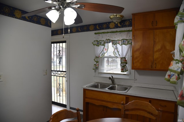 kitchen featuring ceiling fan, a healthy amount of sunlight, and sink