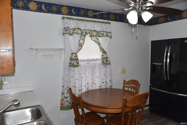 dining area with hardwood / wood-style floors, ceiling fan, and sink