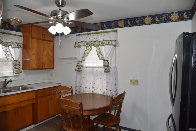 kitchen featuring ceiling fan, stainless steel fridge, dark hardwood / wood-style flooring, and sink