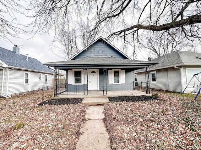 bungalow with central AC unit and a porch