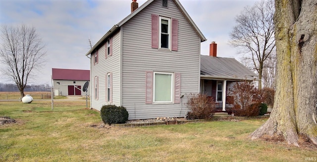 back of house with a yard