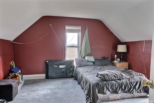 carpeted bedroom with lofted ceiling