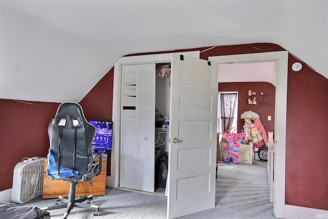 carpeted office with lofted ceiling