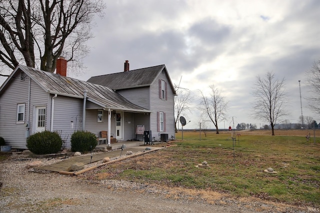 view of property exterior with a lawn and central AC unit