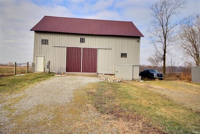 view of outbuilding featuring a lawn