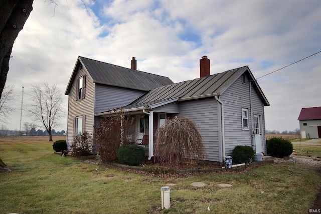 view of side of home featuring a lawn