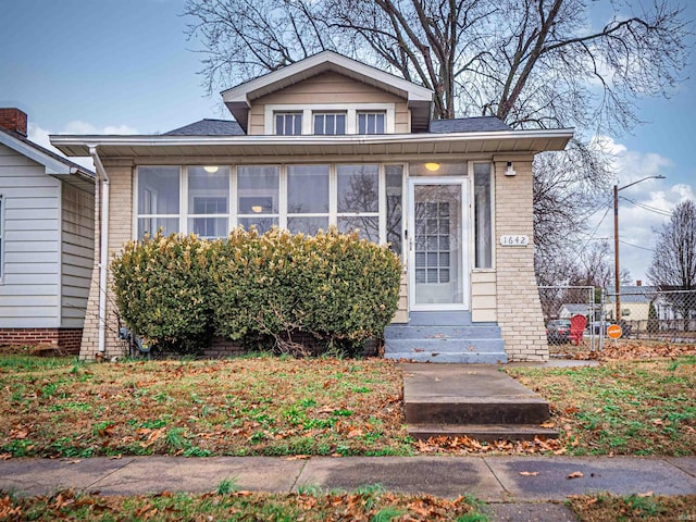 bungalow-style house featuring a sunroom