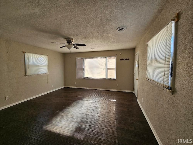 unfurnished room with dark wood-type flooring and ceiling fan