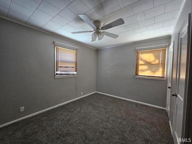 carpeted spare room with ceiling fan and crown molding