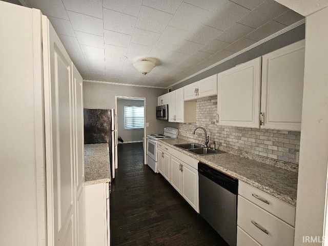 kitchen featuring backsplash, sink, white cabinetry, dark wood-type flooring, and appliances with stainless steel finishes