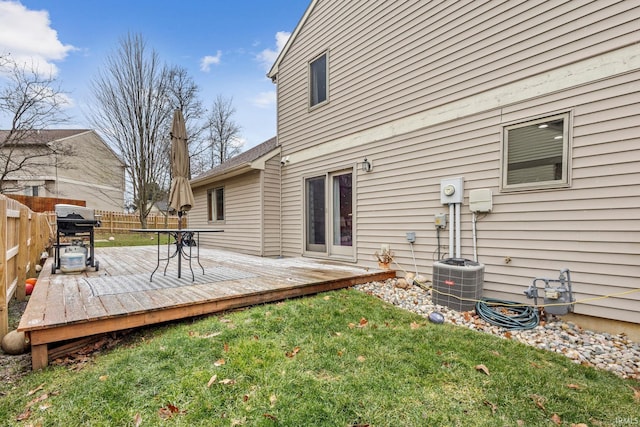 back of property featuring a yard, a wooden deck, and central AC