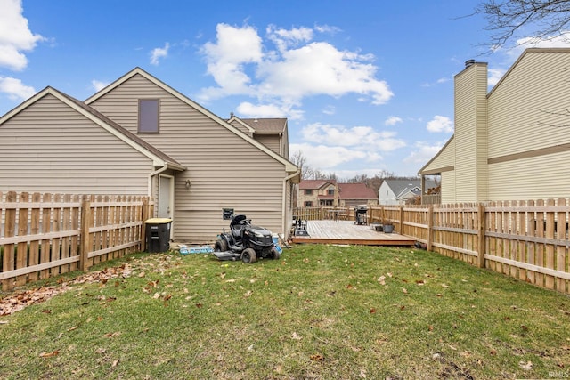 back of house featuring a yard and a wooden deck