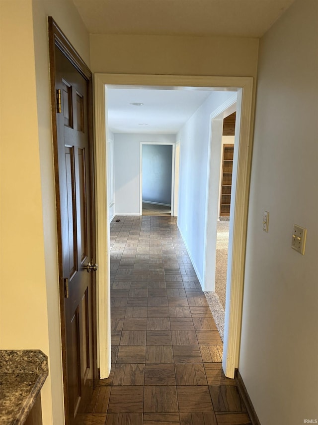 hallway with dark parquet flooring