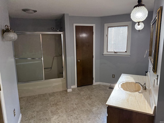 bathroom featuring vanity and enclosed tub / shower combo