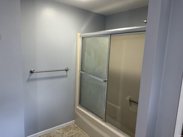 bathroom with tile patterned floors and a shower with shower door