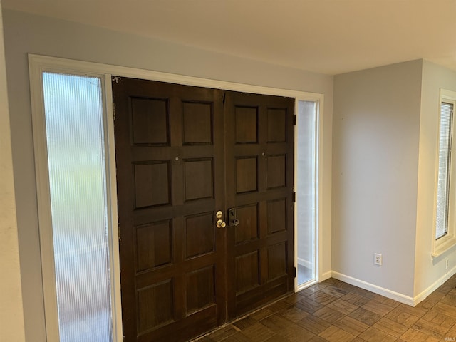 foyer featuring dark parquet flooring