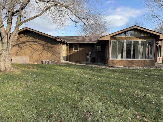 view of property exterior with a sunroom and a yard