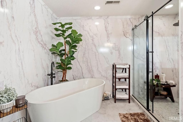 bathroom with plus walk in shower and tile walls