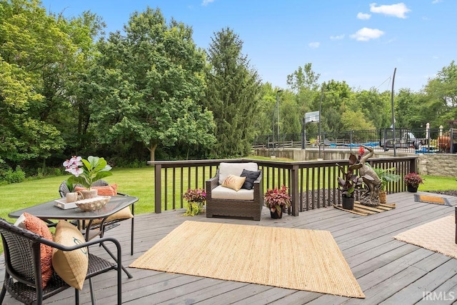 wooden terrace featuring a lawn