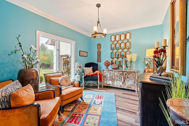 living area with light hardwood / wood-style floors, ornamental molding, and a chandelier