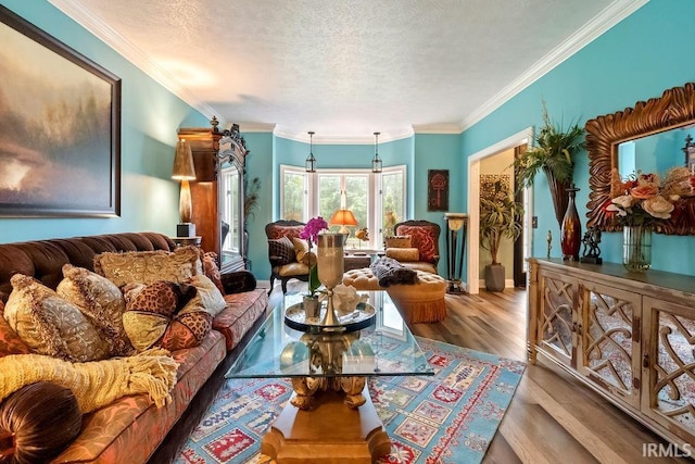 living room with a textured ceiling, light wood-type flooring, and ornamental molding