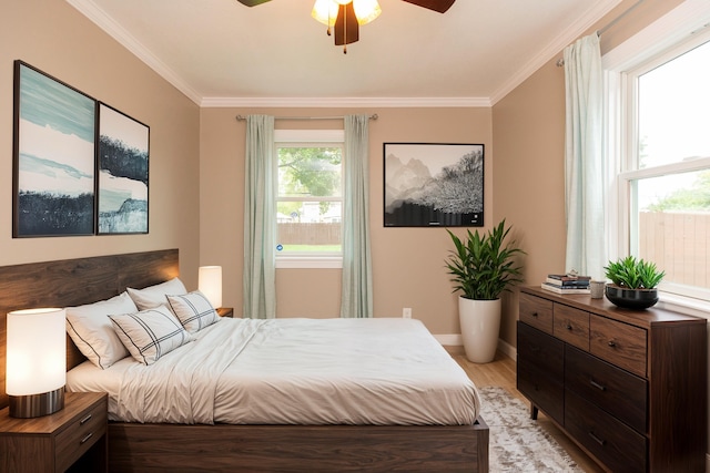 bedroom featuring ceiling fan, light hardwood / wood-style floors, and ornamental molding