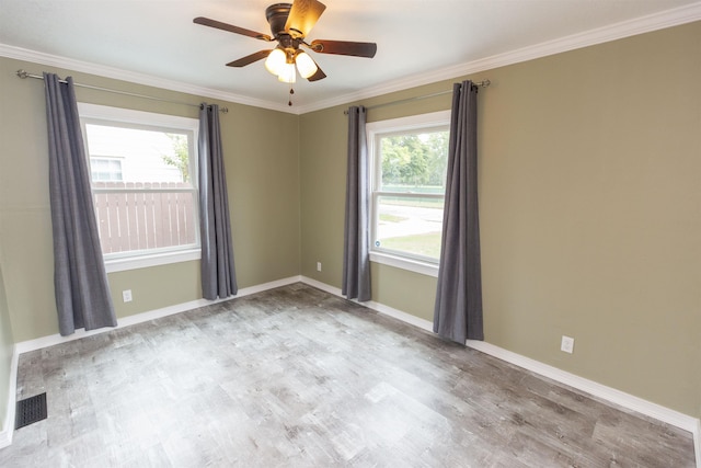 empty room with ceiling fan, light hardwood / wood-style floors, and crown molding