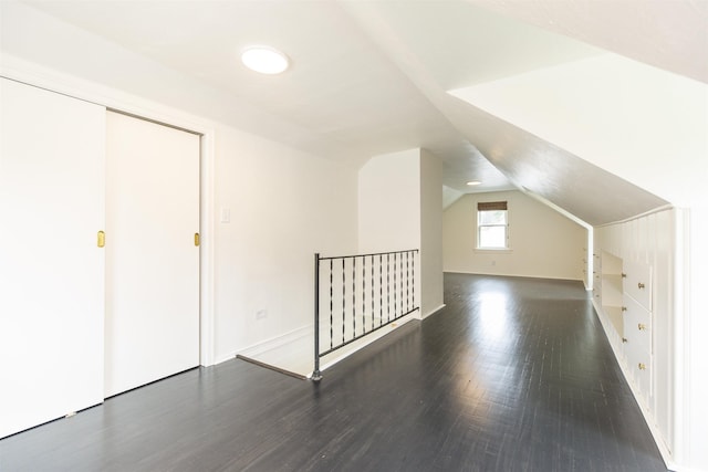 bonus room with dark hardwood / wood-style floors and lofted ceiling