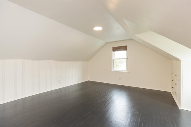 bonus room featuring dark hardwood / wood-style flooring and lofted ceiling