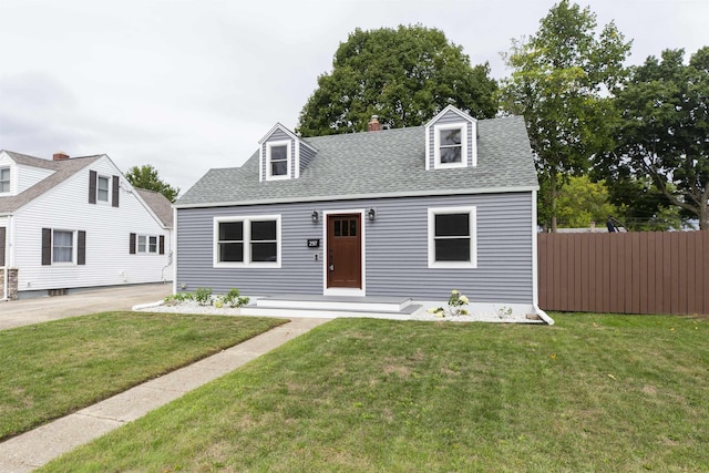 new england style home featuring a front lawn