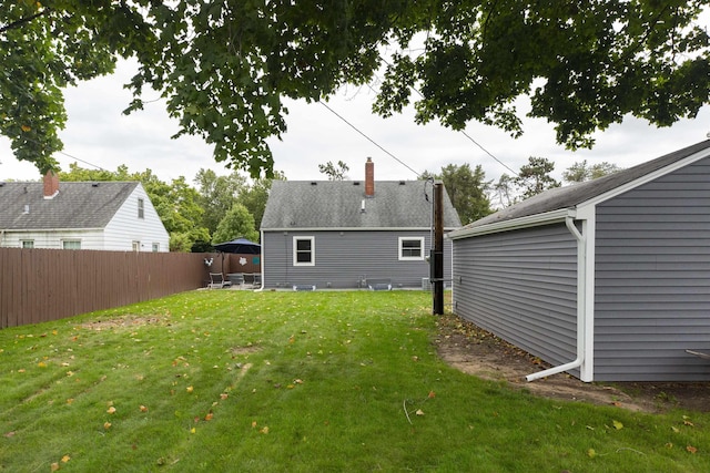 rear view of house with a lawn