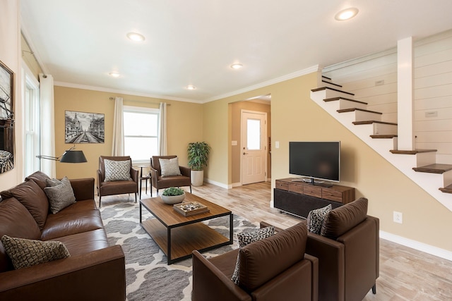 living room with crown molding and light hardwood / wood-style floors