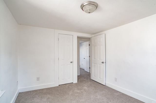 unfurnished bedroom featuring light colored carpet