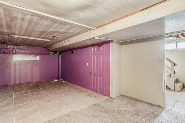 basement featuring light colored carpet and wooden ceiling