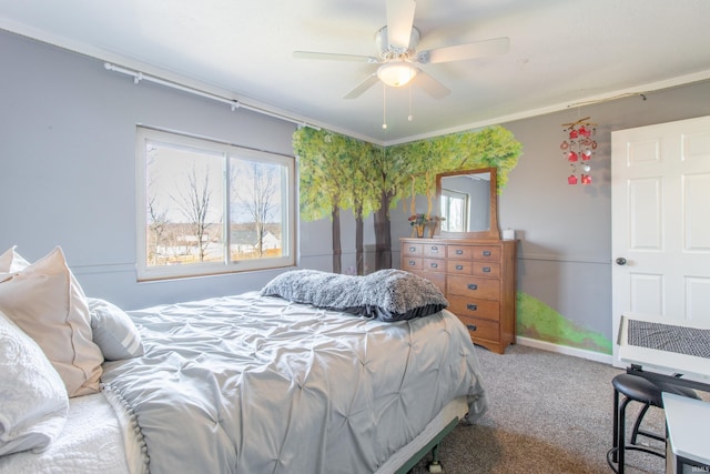 bedroom featuring multiple windows, ceiling fan, and carpet floors