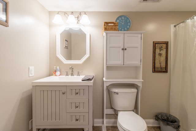 bathroom featuring vanity and toilet