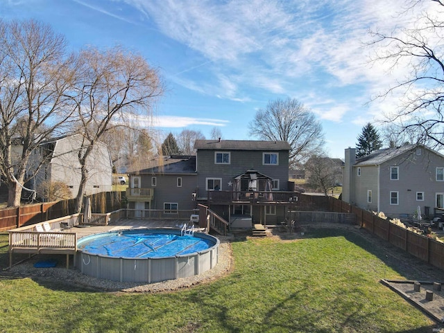 back of property featuring a swimming pool side deck, a lawn, and a gazebo