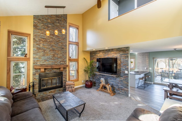 living room with carpet floors, a fireplace, and high vaulted ceiling