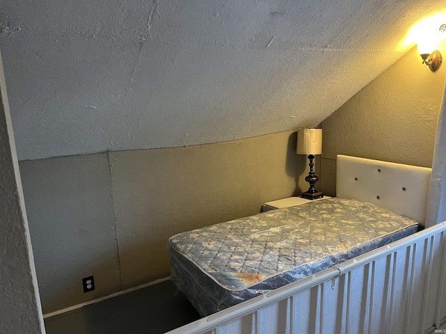 bedroom featuring vaulted ceiling