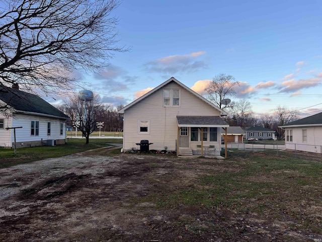 back house at dusk featuring central air condition unit