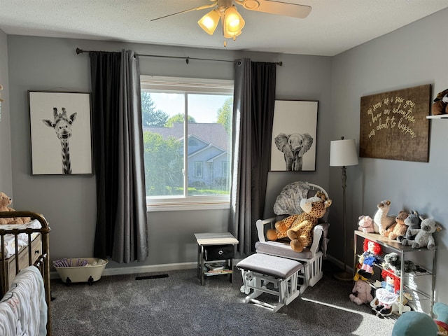 carpeted bedroom with multiple windows, ceiling fan, and a textured ceiling