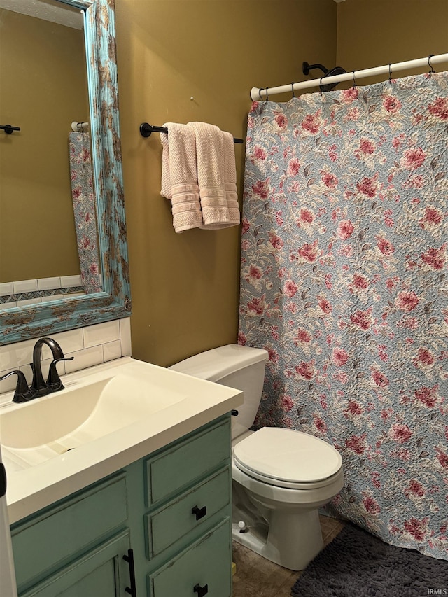 bathroom featuring tile patterned floors, vanity, toilet, and tasteful backsplash