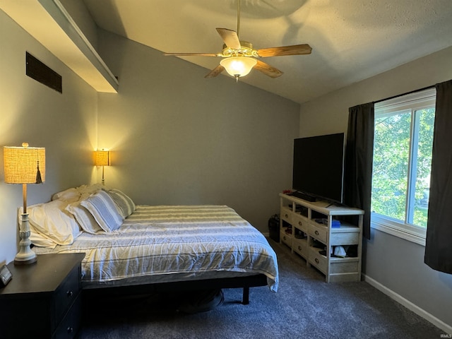 bedroom with ceiling fan, carpet floors, and vaulted ceiling