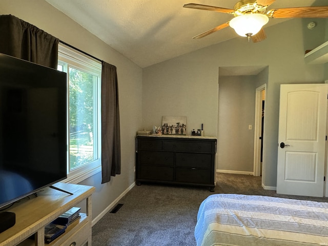 carpeted bedroom featuring multiple windows, ceiling fan, and lofted ceiling