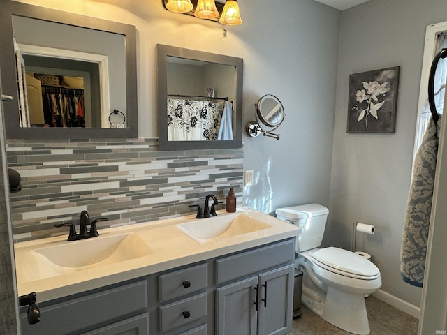 bathroom with backsplash, tile patterned floors, vanity, and toilet