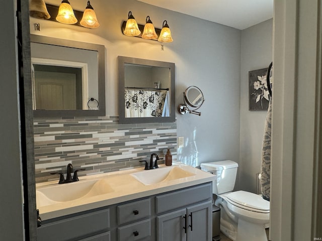 bathroom with vanity, toilet, and backsplash